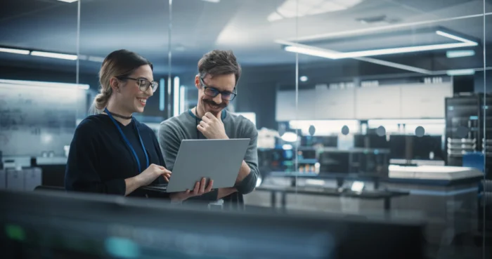 man and woman on a computer in server room